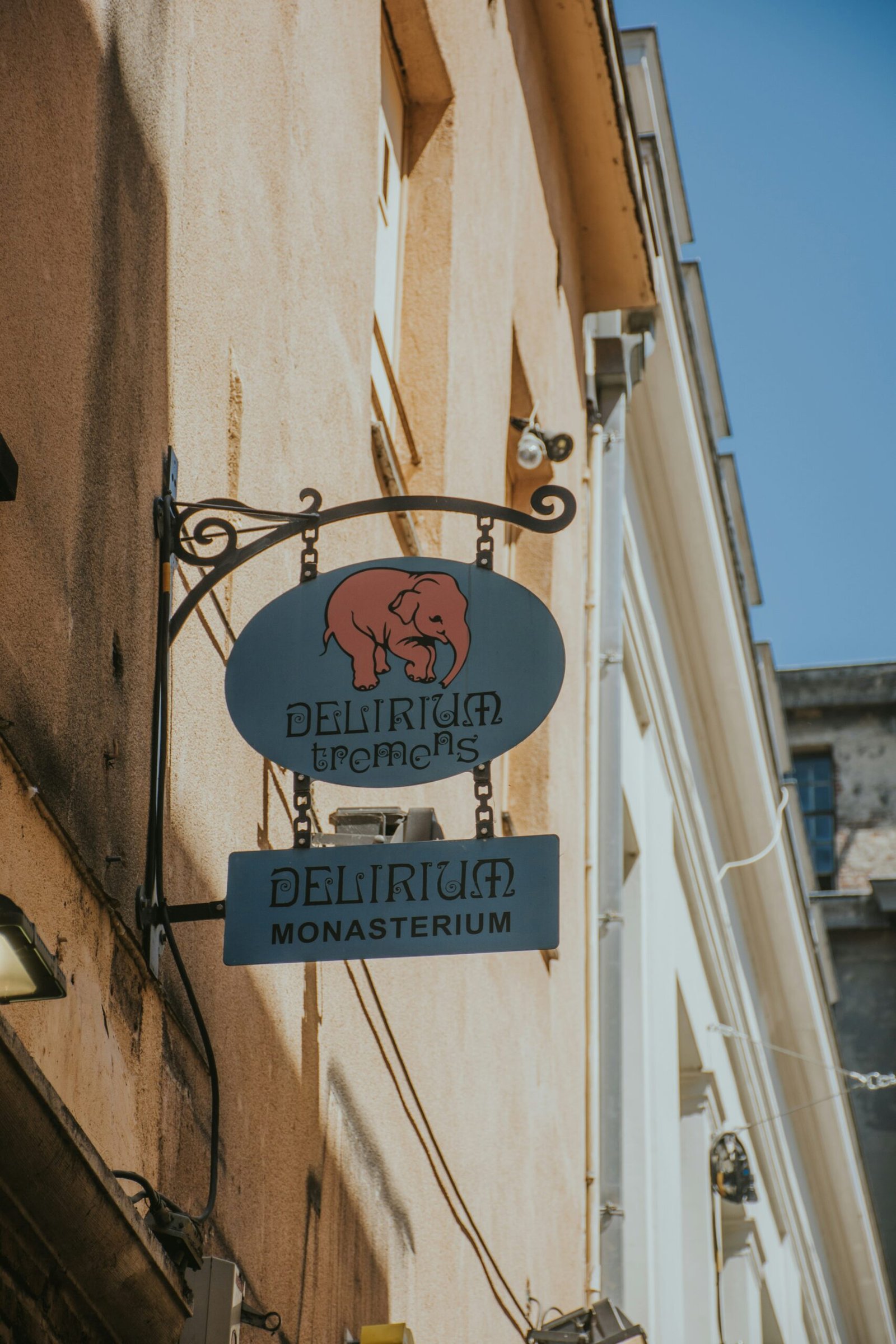 a blue sign hanging from the side of a building