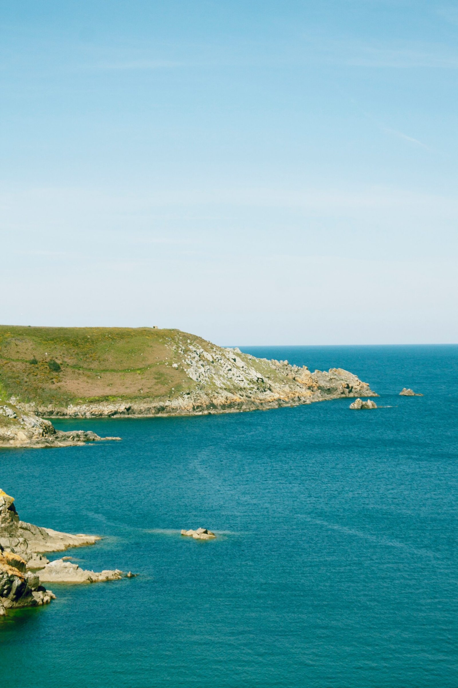brown island and blue water