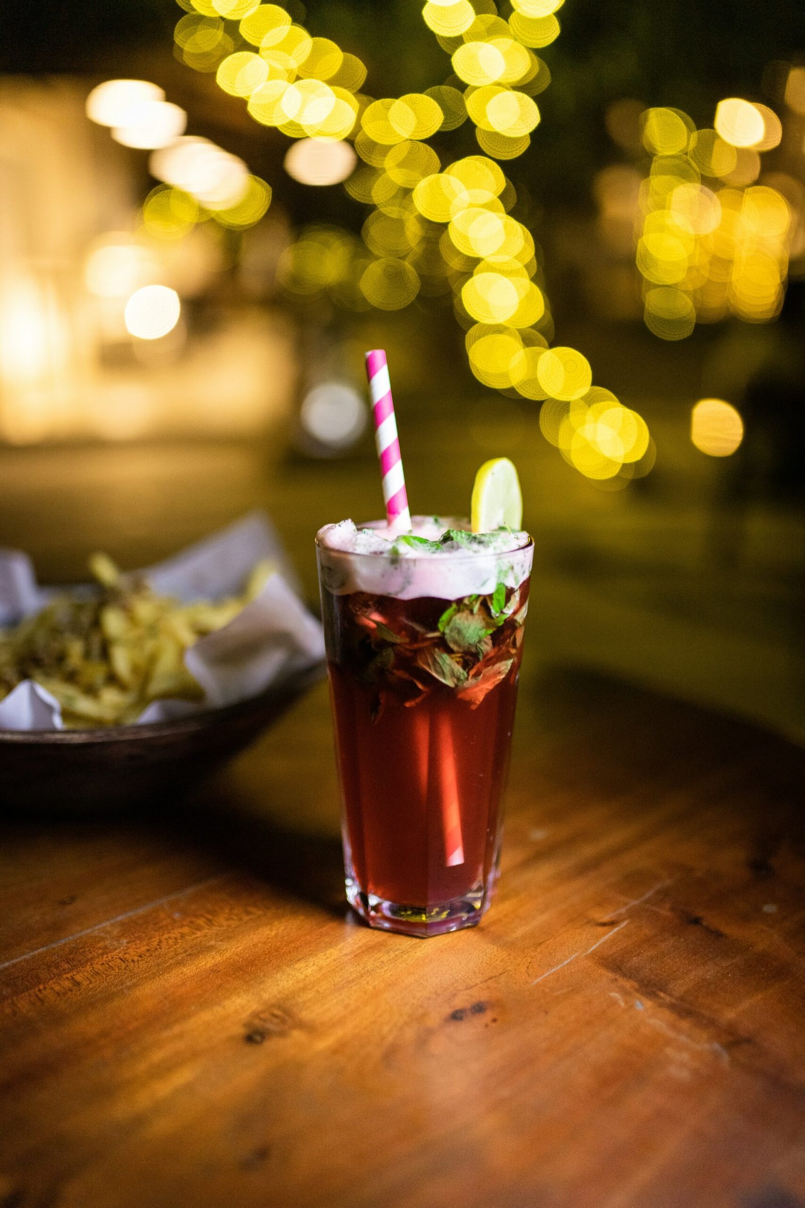 clear drinking glass with brown liquid and ice